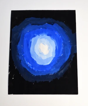 An abstract blue and white monocolor radial gradient made by a child.