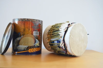 An handmade drum made out of a tin of snacks.